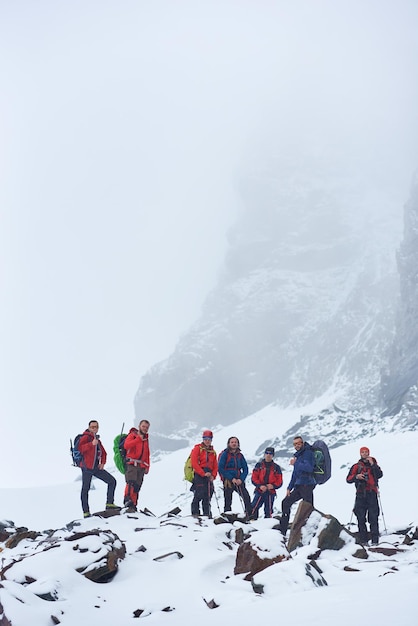 Group of mountaineers standing on rocky hill