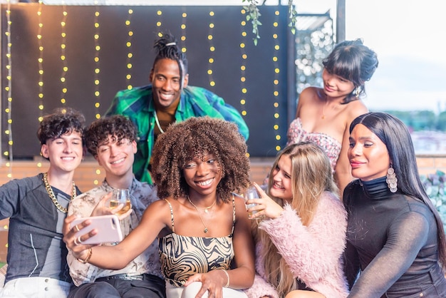 A group of multi-ethnic friend taking a selfie on a terrace in new year's eve