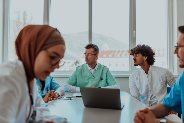 a group of multiethnic medical professionals including doctors surgeons and nurses are gathered in