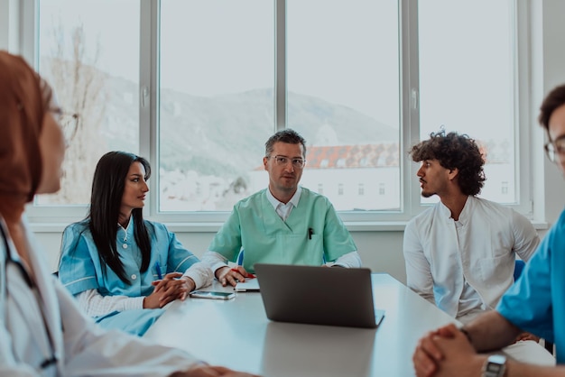 a group of multiethnic medical professionals including doctors surgeons and nurses are gathered in