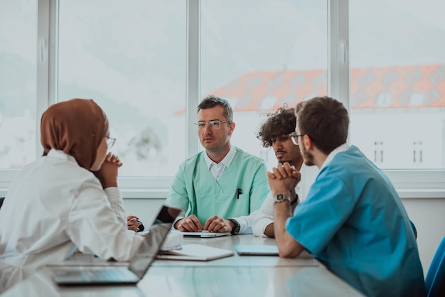 a group of multiethnic medical professionals including doctors surgeons and nurses are gathered in