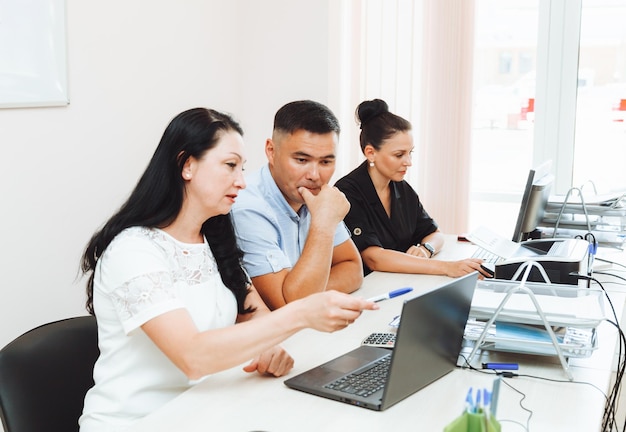 A group of multinational business people working in a modern office people in the office at the computer