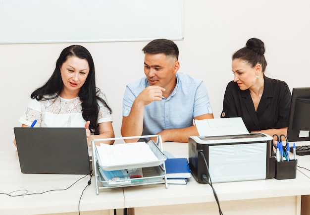 A group of multinational business people working in a modern office people in the office at the computer