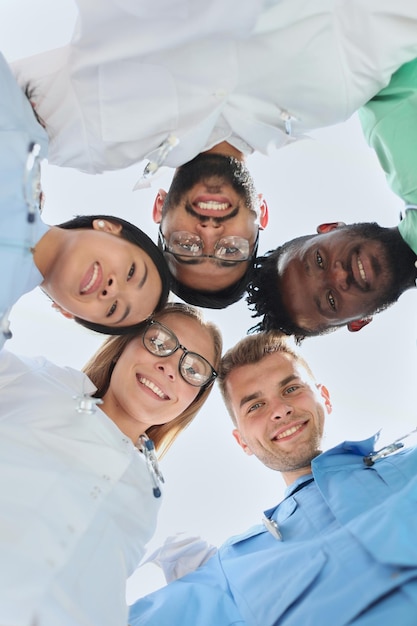 Group of multinational interns looking down smiling