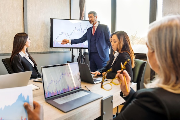 Group of multiracial colleagues discussing business ideas in office