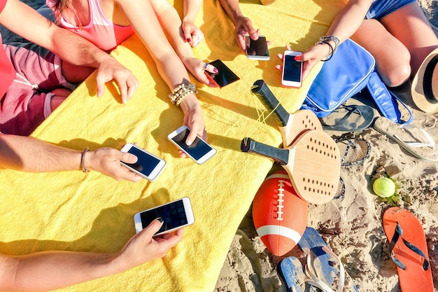 Group of multiracial friends having fun together with smartphone