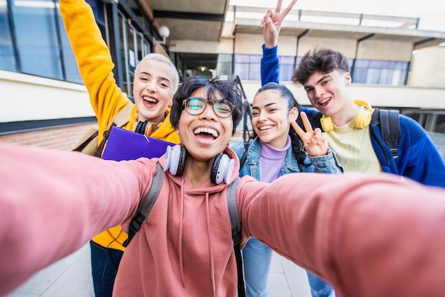 Group of multiracial students taking selfie picture at school