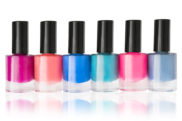 Group of nail polishes in a row isolated on white background