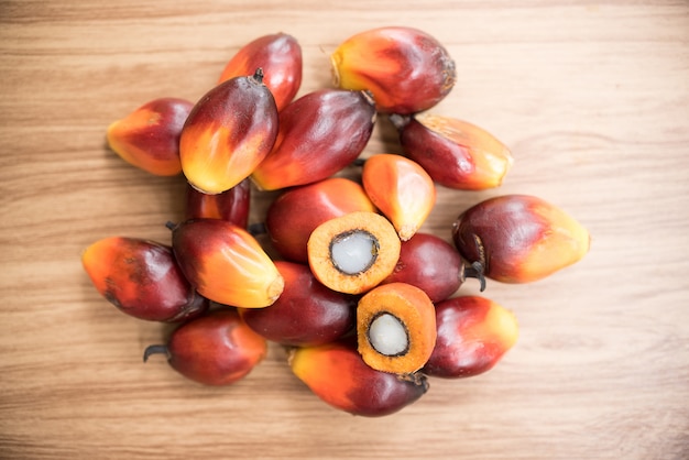 A group of oil palm fruits on wood table