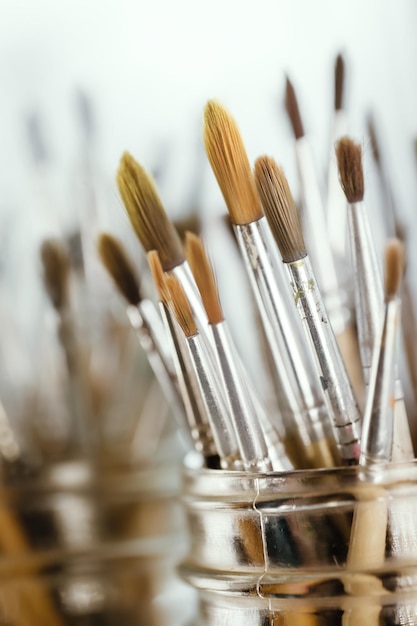 Group of old used paintbrushes with clean background