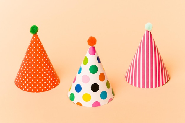 Group of party hats isolated on beige background