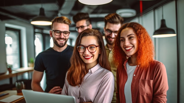 A group of people are gathered around a laptop.