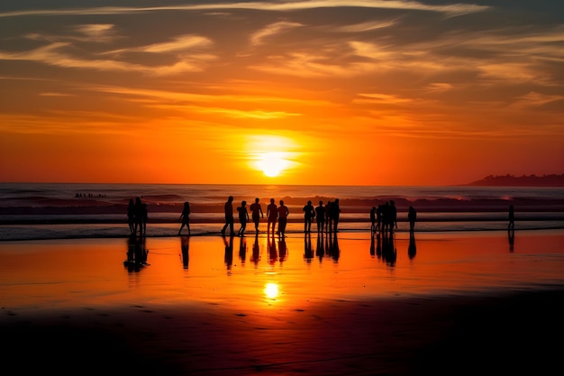 A group of people are standing on a beach with the sun setting behind them.