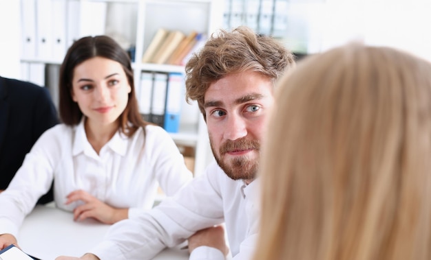 Group of people deliberate on white board