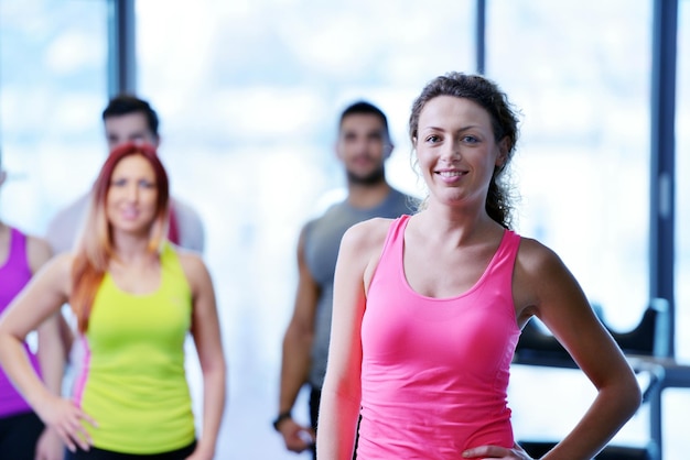 Group of people exercising at the gym and stretching