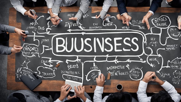 a group of people holding a chalkboard that says business business