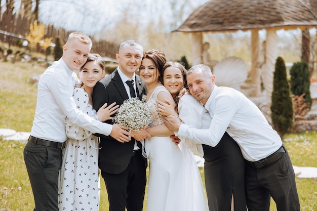 A group of people including a bride and groom