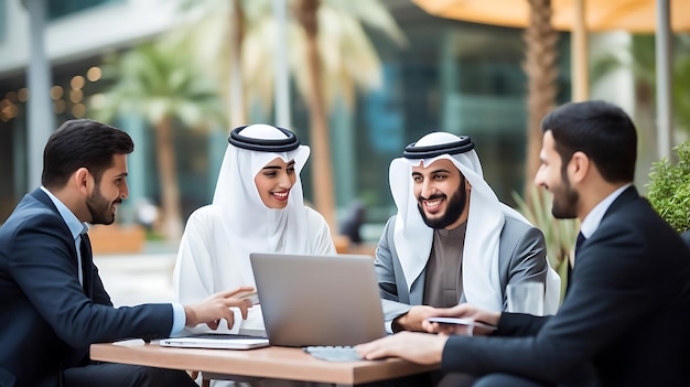 a group of people including a man in a black suit and a white woman sit at a brown wooden table using laptops one man wears a white and black hat and another