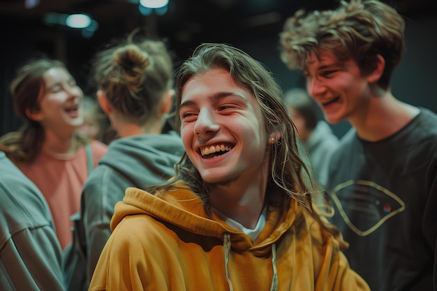 A group of people laughing and laughing together in a room with lights on the ceiling and a woman in