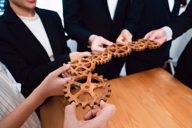 Photo group of people making chain of gears into collective form for harmony symbol