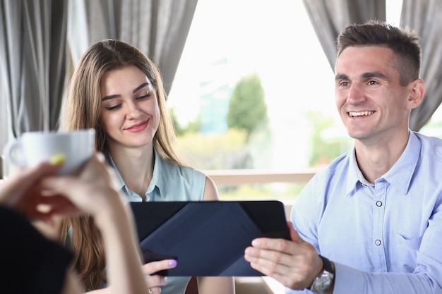 Group of people in office look at mobile tablet pc