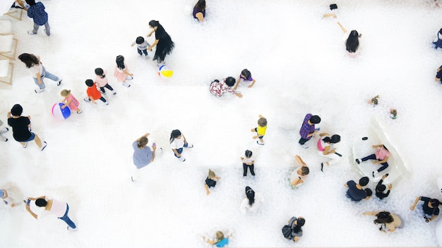 group of people play and run on the white bubble playground