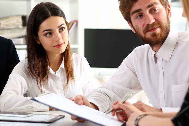 Group of people sit in office deliberate on problem