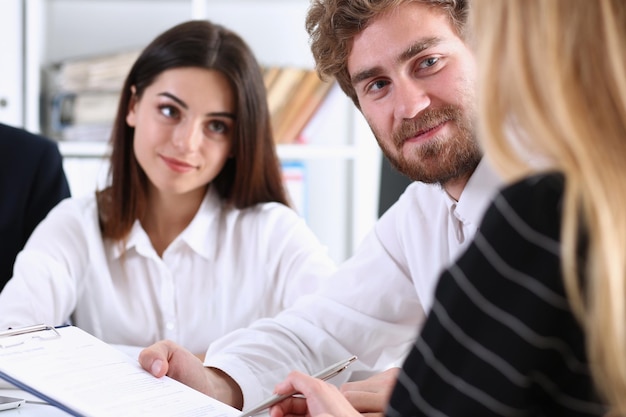 Group of people sit in office deliberate on problem