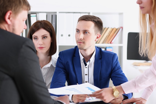 Group of people sit in office deliberate