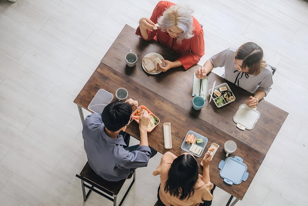 a group of people sit at a table with a magazine on it