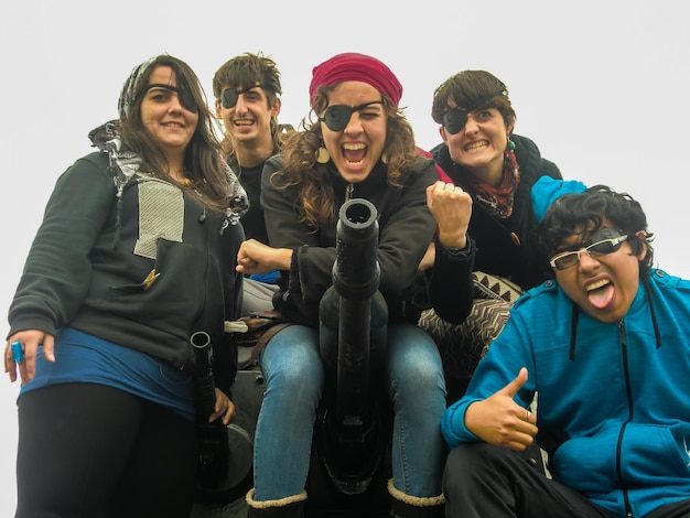 Group of people sitting on a museum display tank.