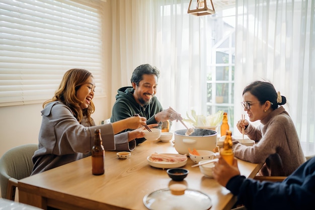 a group of people sitting at a table with food and drinks