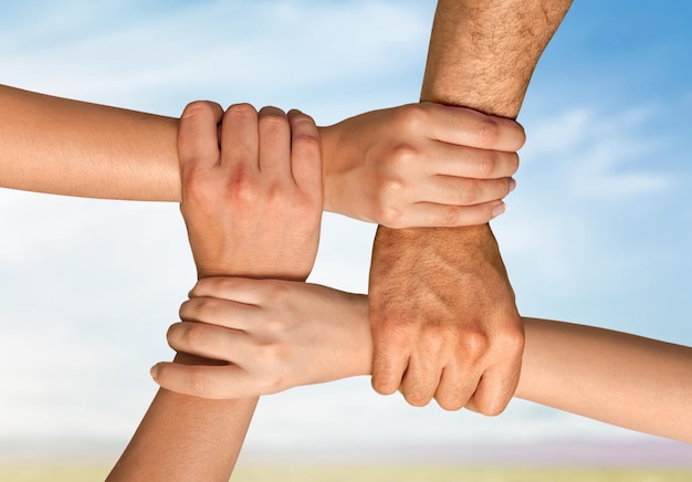 Group of people stacking hands together