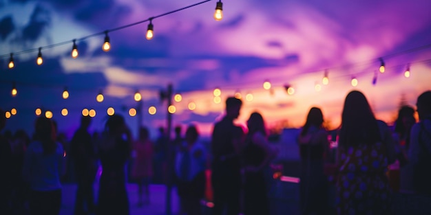 Photo a group of people standing under a purple sky with lights in the background