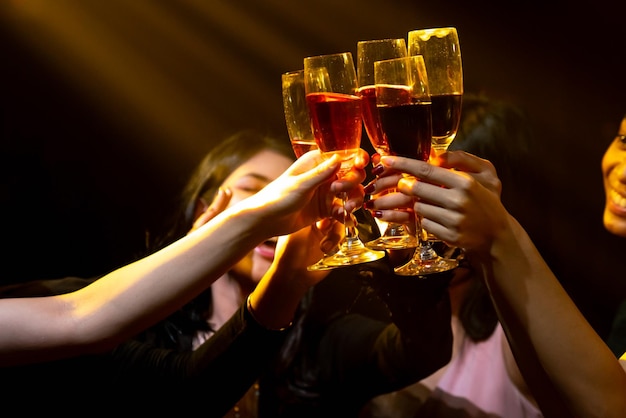 Group of people toast drinks at party in dancing club