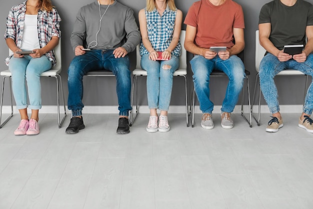 Group of people waiting for job interview on chairs