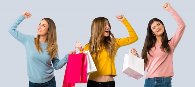 Group of people with colorful clothes holding a lot of shopping bags