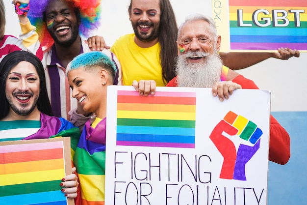 Group of people with rainbow flags and banners during Gay Pride event 