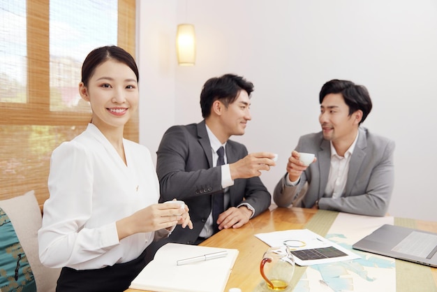 Group of people working out business plan in house tea