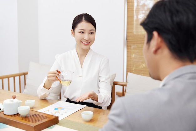 Group of people working out business plan in house tea