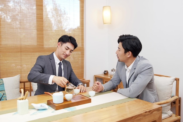 Group of people working out business plan in house tea