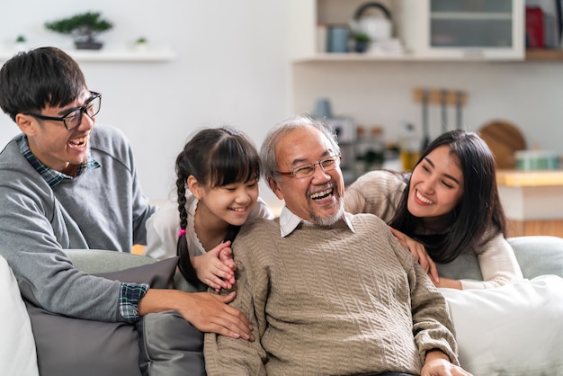 Group Portrait of Happy Asian family Sitting on Sofa