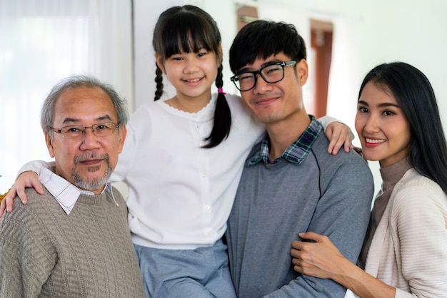 Group Portrait of Happy multigenerational asian family standing in living room