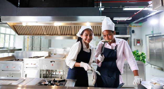 Group portrait young wman cooking student Cooking class culinary classroom group of happy young woman multi ethnic students are focusing on cooking lessons in a cooking school