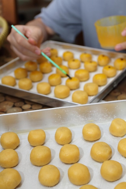 Group of raw Nastars or Pineapple Tarts before egg yolk wash Selective focus