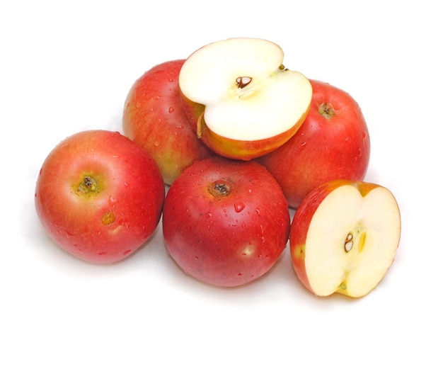 A group of red apples with one being cut in half