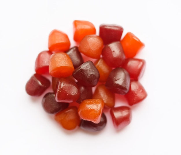 Group of red orange and purple multivitamin gummies isolated on white background healthy lifestyle