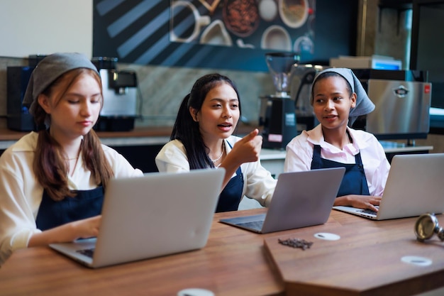 Group schoolgirl studying hard to learn how to make espresso coffee at barista school