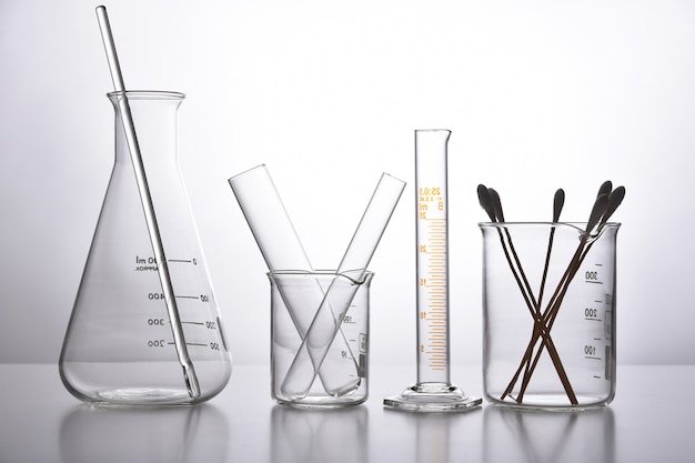 Group of scientific laboratory glassware with clear liquid solution, Science research and development concept.