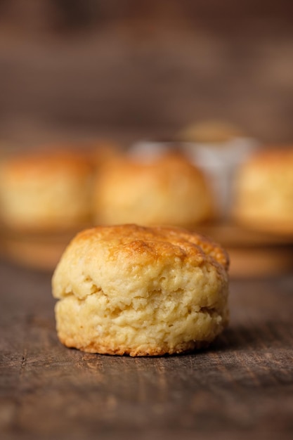 Group of scones on wood plate with jam on table